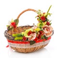 Wicker brown oval basket decorated with various flowers