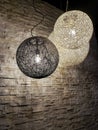 Wicker cane electric globe lighting hanging from the ceiling Royalty Free Stock Photo