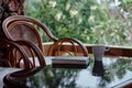 Wicker chair on balcony, cup of coffee and book