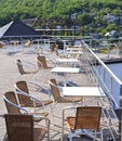 Wicker chairs with metal legs and racks are in an open cafe area Royalty Free Stock Photo