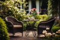 Wicker chairs and a metal table in an outdoor summer garden Royalty Free Stock Photo