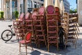 Wicker chairs of a street cafe stacked in a pile. Royalty Free Stock Photo