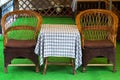 Wicker chairs and table with tablecloth. Cafe on the street. Retro furniture Royalty Free Stock Photo