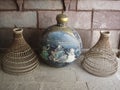 Wicker cloches and antique decorative painted metal vase