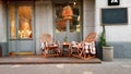 Wicker cozy armchair with blanket and small glass table outdoors. Plaid lies on the wicker furniture from rattan. Royalty Free Stock Photo