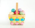 Wicker Easter basket filled with colorful eggs isolated on white Royalty Free Stock Photo