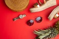 Wicker fashionable bag, sunglasses, tropical pineapple and expensive watches and women`s shoes. Summer fashion, the concept of th