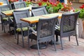 Wicker furniture flowers of a street cafe Royalty Free Stock Photo