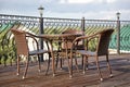 Wicker furniture on the veranda in the summer cafe. Table and chairs, cafe without visitors. Royalty Free Stock Photo