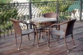 Wicker furniture on the veranda in the summer cafe. Table and chairs, cafe without visitors. Royalty Free Stock Photo