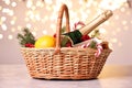 Wicker gift basket with sparkling wine and Christmas decor on light textured table Royalty Free Stock Photo