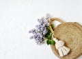 Wicker Handbag with Lilac Flowers , Spring Time, Summer Concept Royalty Free Stock Photo