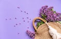 Wicker Handbag with Lilac Flowers, Spring Time, Summer Creative Concept Royalty Free Stock Photo