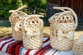 Wicker handbags made of natural bleached dried corn leaves against the backdrop of a rural landscape in blur