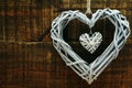 Wicker heart decoration on grunge wooden background valentine`s day concept