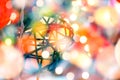 Wicker lanterns hanging in the Christmas tree on blurred and bokeh reflection lighting of lights decorating the Christmas tree