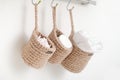 wicker mini baskets hanging on a wall. toiletry storage in bathroom. eco natural jute hand made basket. cozy