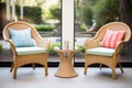 wicker patio chairs with a glass-top side table Royalty Free Stock Photo