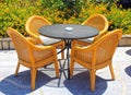 Wicker patio chairs and table in the garden Royalty Free Stock Photo