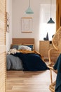 Wicker peacock chair in bright kid`s bedroom interior with wooden furniture Royalty Free Stock Photo