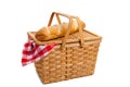 Wicker picnic basket with bread on white Royalty Free Stock Photo