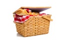 Wicker picnic basket with bread on white