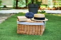 Wicker picnic basket  with flowers on grass in garden. Weekend concept. Picnic basket with a book and a bouquet of lavender on the Royalty Free Stock Photo
