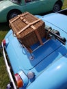 Wicker picnic basket on rear of a British classic sports car. Royalty Free Stock Photo