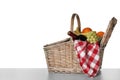 Wicker picnic basket with wine and different fruits on white background Royalty Free Stock Photo