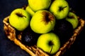 Wicker platter full of apples and avocados Royalty Free Stock Photo