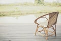 Wicker rattan chair on balcony terrace patio near pond Royalty Free Stock Photo