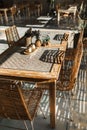 Wicker rattan handmade chairs and wooden table. Trendy furniture design Royalty Free Stock Photo