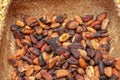 Wicker robe made of bamboo strips filled with fresh cocoa beans. Close up of shelled cocoa beans from cacao pod. Cacao beans Royalty Free Stock Photo