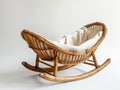 A wicker rocking chair with a white cushion Royalty Free Stock Photo