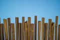 Wicker roof beach umbrella and blue sky. Natural bamboo sunshades and summer umbrella parasol on blue sea shore Royalty Free Stock Photo