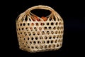 Wicker round bamboo basket on black Royalty Free Stock Photo