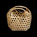 Wicker round bamboo basket on black Royalty Free Stock Photo