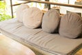 wicker sofa with brown cushion and pillow