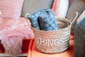 Wicker storage basket with woolen blanket inside and cushions