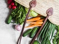 Wicker straw bag full of fresh natural spring vegetables. Healthy vegetarian vegan food from the local market from farms Royalty Free Stock Photo