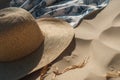 Wicker straw hat and blue white sarong pareo on beach sand. Summer sea vacation concept Royalty Free Stock Photo