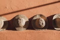 Wicker straw hats on background of terracotta color wall in Morocco