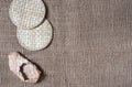 Wicker straw stands and bast shoes on gunny background. Flatlay, topview, copyspace, minimalism, natural eco