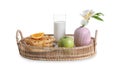 Wicker tray with delicious breakfast and beautiful flower on white background Royalty Free Stock Photo