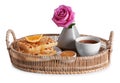 Wicker tray with delicious breakfast and beautiful flower on white background Royalty Free Stock Photo