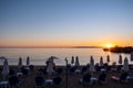 Wicker umbrella silhouette at Stoupa sandy beach at sunset. Mani Messenia, Greece Peloponnese