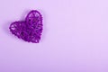 Wicker Valentine on a purple background. St. Valentine`s Day.