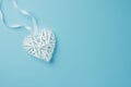 Wicker White Decorative Heart on Light Blue Background Corner Position. Valentine Mother`s Day Romantic