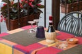 Wicker wine bottle on a tuscan restaurant table Royalty Free Stock Photo
