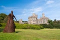Wicker woman statue and castle in Stornoway, United Kingdom. Willow sculpture on green grounds of Lews Castle estate